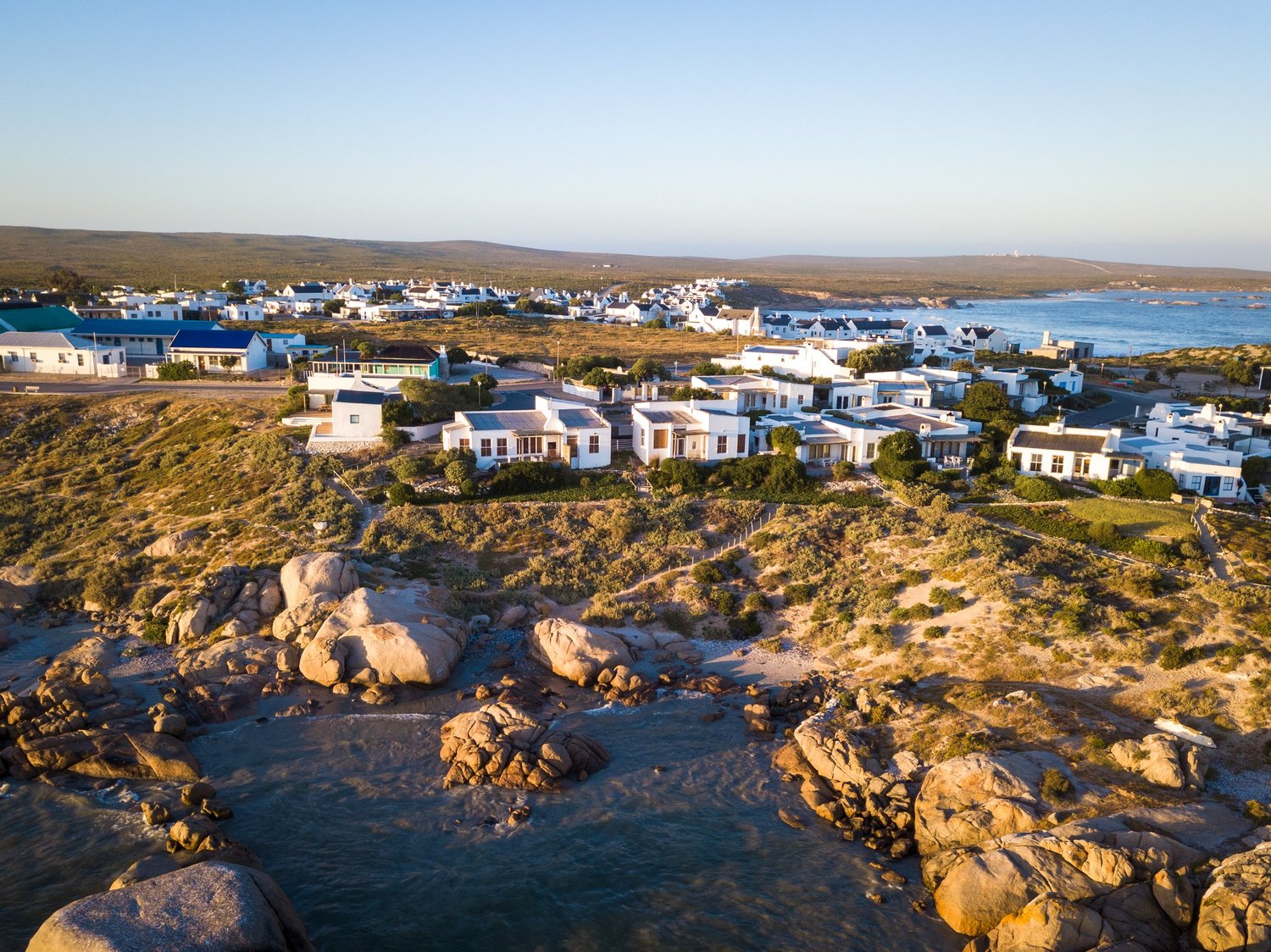 Paternoster from the air, the village running down to the granite shore