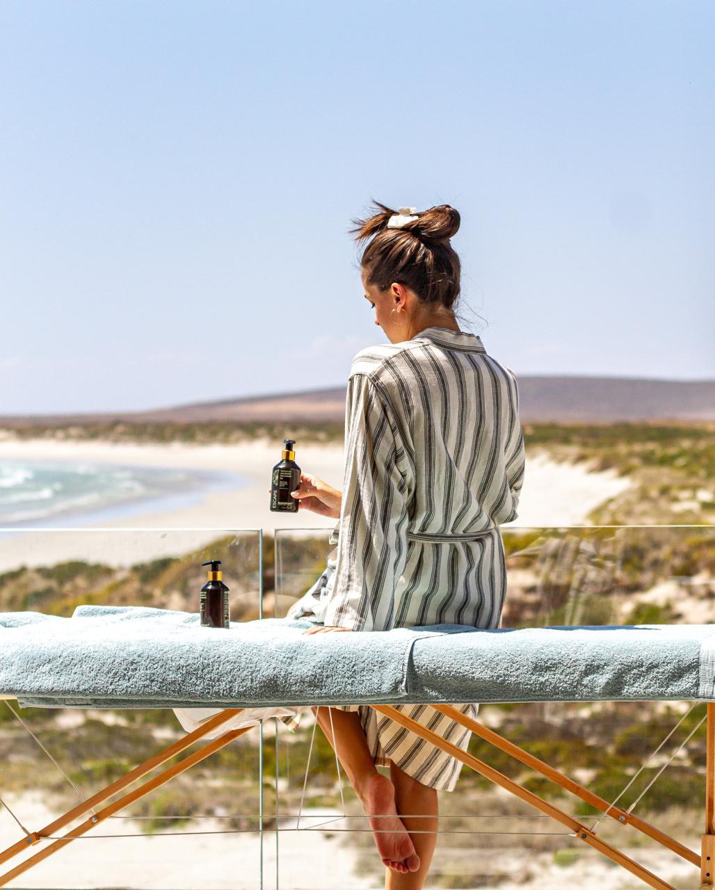 A guest on a massage table above the beach at Elements Wellness