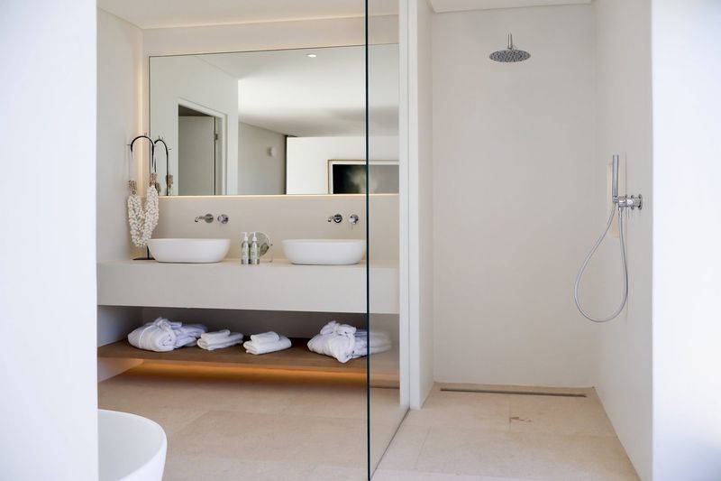 BURI House — bathroom with double vanity and rain shower